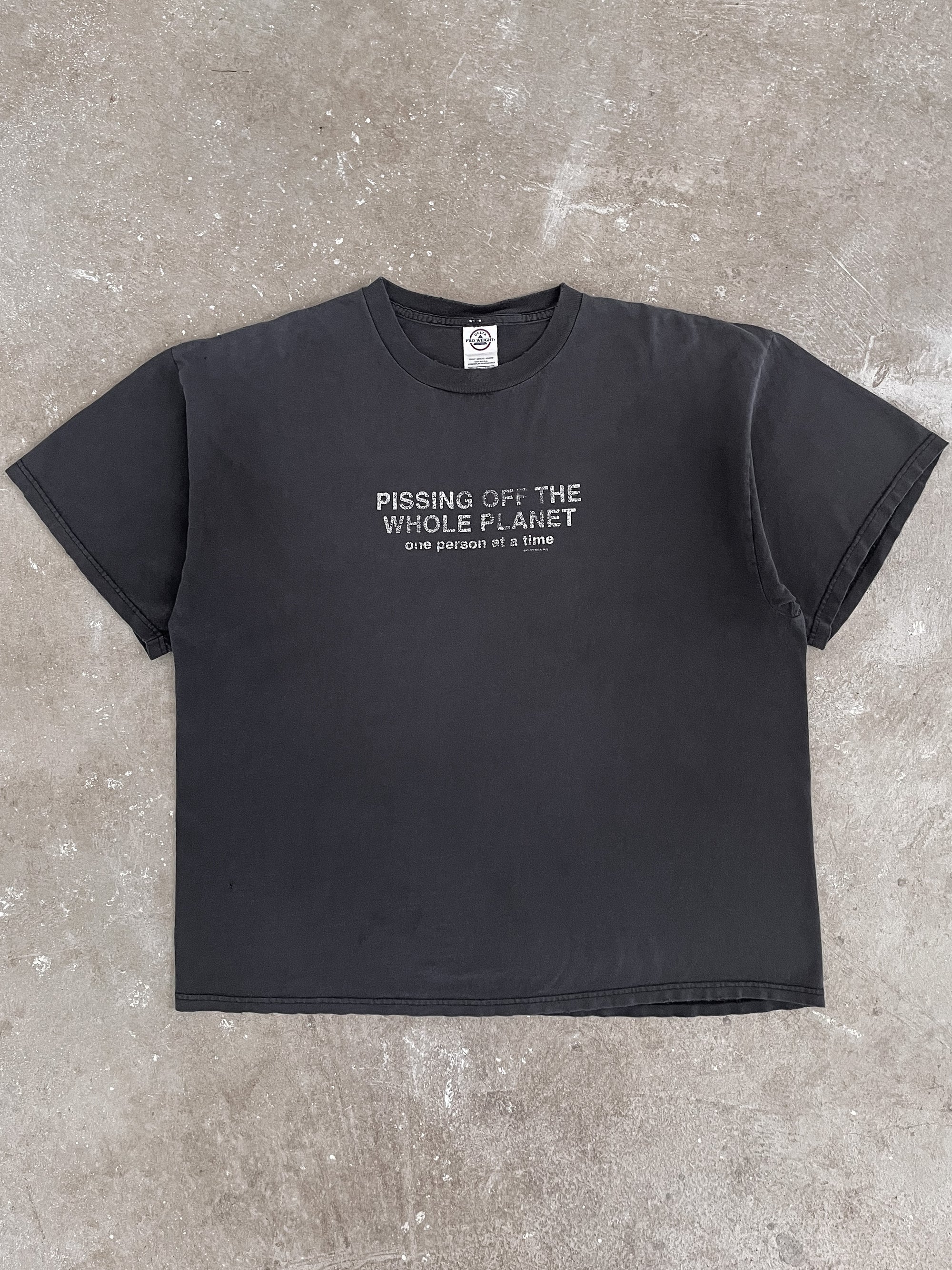 2000s “Pissing Off The Whole Planet…” Faded Tee (XL)