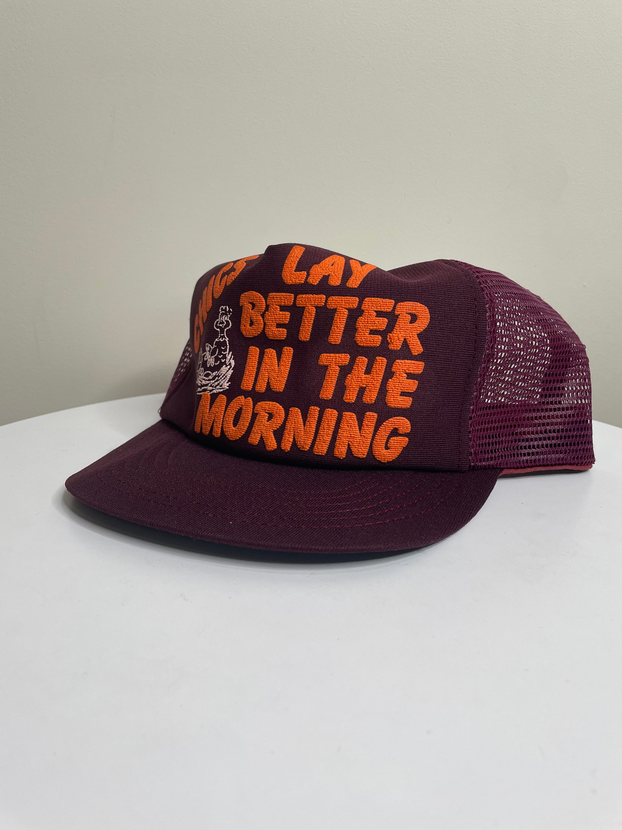 1980s “Chics Lay Better In The Morning” Trucker Hat