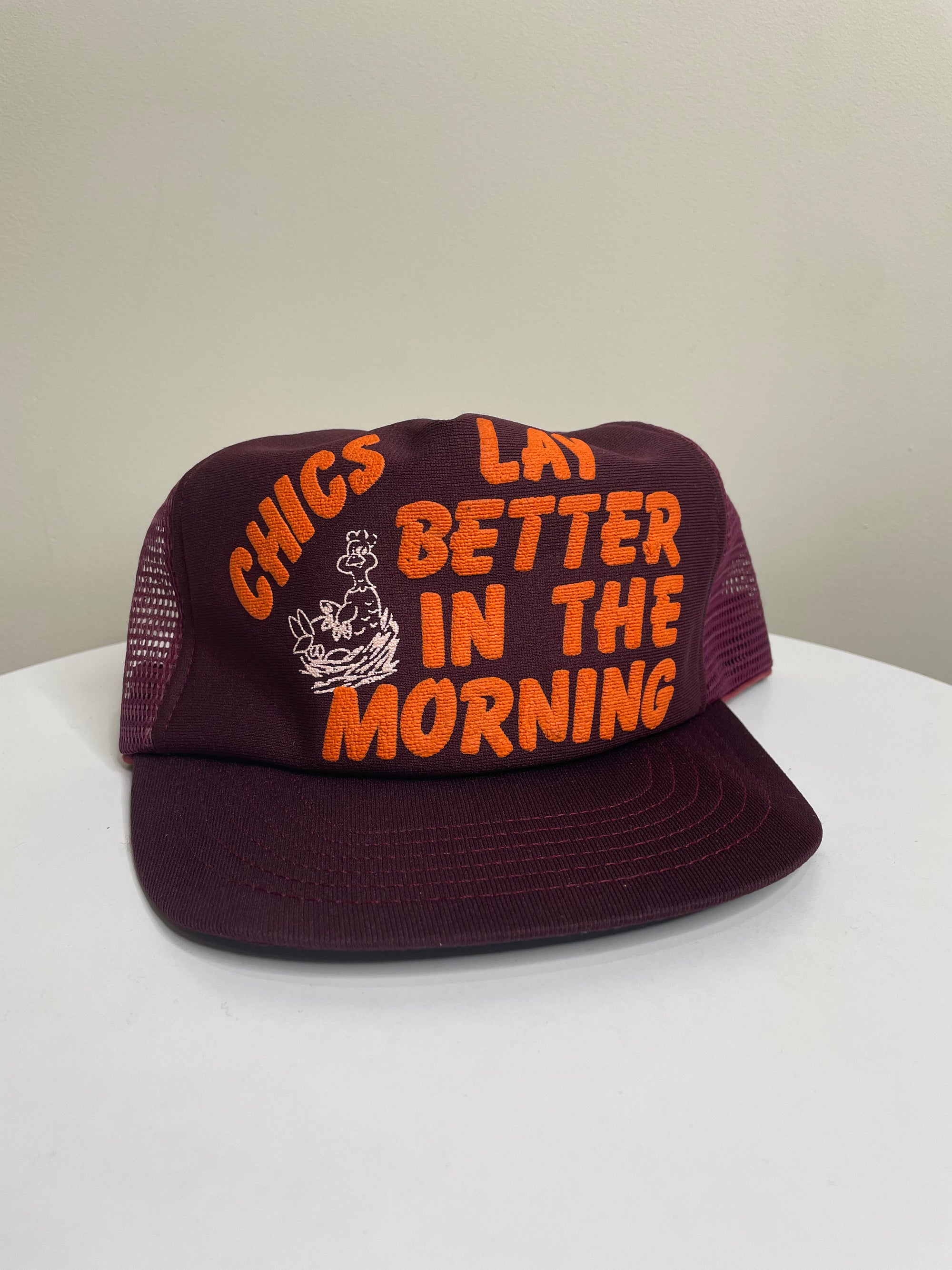 1980s “Chics Lay Better In The Morning” Trucker Hat